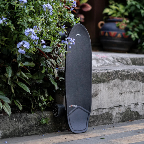 Exway Wave electric skateboard outdoors with flowers
